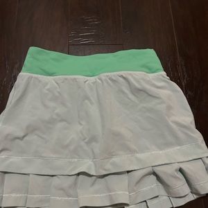 ivivva tennis skirt. color is mint green, size 10 kids